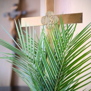 a palm tree in a vase with a cross on it