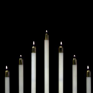 seven white candles closeup photography
